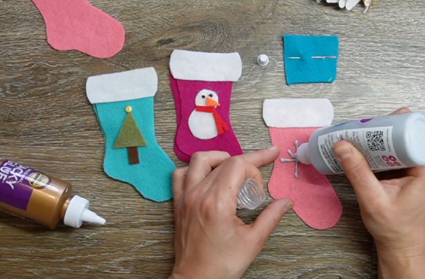 glue or sew your decorative pieces to the front piece of your stocking, let dry