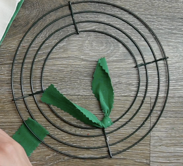 start to tie the fabric strips to the wire sections on the wreath frame