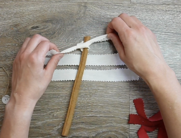 tie fabric strips to the cinnamon stick in desired order